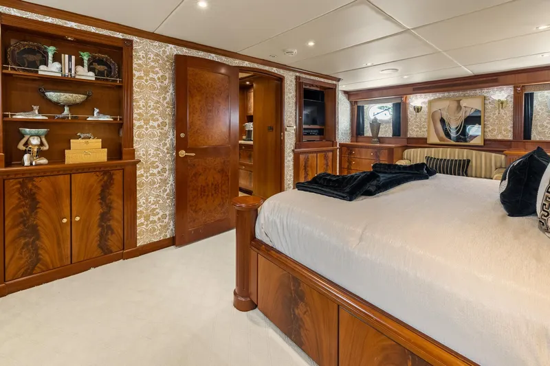  Yacht Photos Pics Luxurious 1999 Trinity Yachts Raised Pilothouse bedroom with elegant wood finishes and decor.