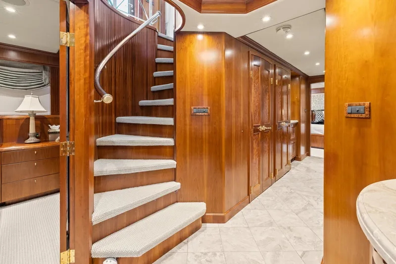  Yacht Photos Pics Luxurious wooden interior of 1999 Trinity Yachts Raised Pilothouse with elegant staircase.