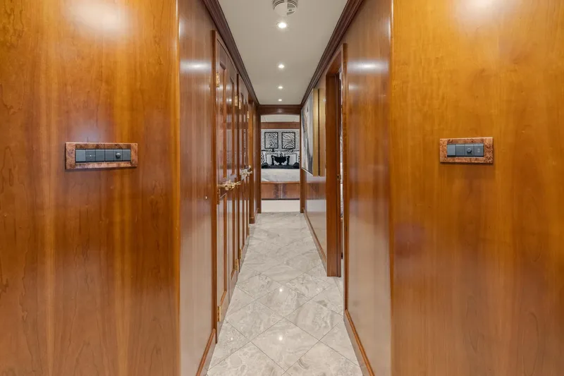  Yacht Photos Pics Luxurious wooden hallway interior of 1999 Trinity Yachts Raised Pilothouse with marble flooring.