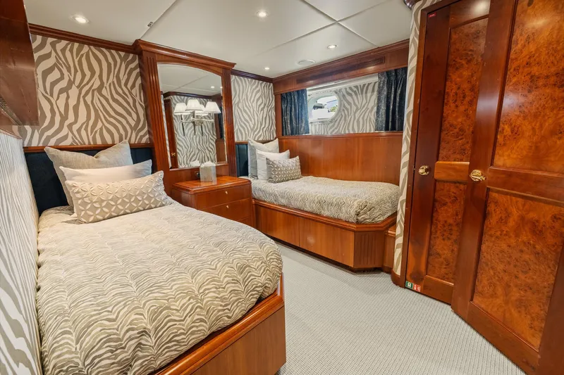  Yacht Photos Pics Luxurious twin bedroom on 1999 Trinity Yachts Raised Pilothouse with elegant wood finishes.