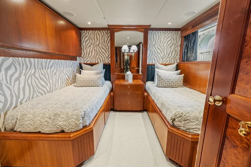  Yacht Photos Pics Luxurious twin bedroom on 1999 Trinity Yachts Raised Pilothouse, featuring elegant wood finishes.