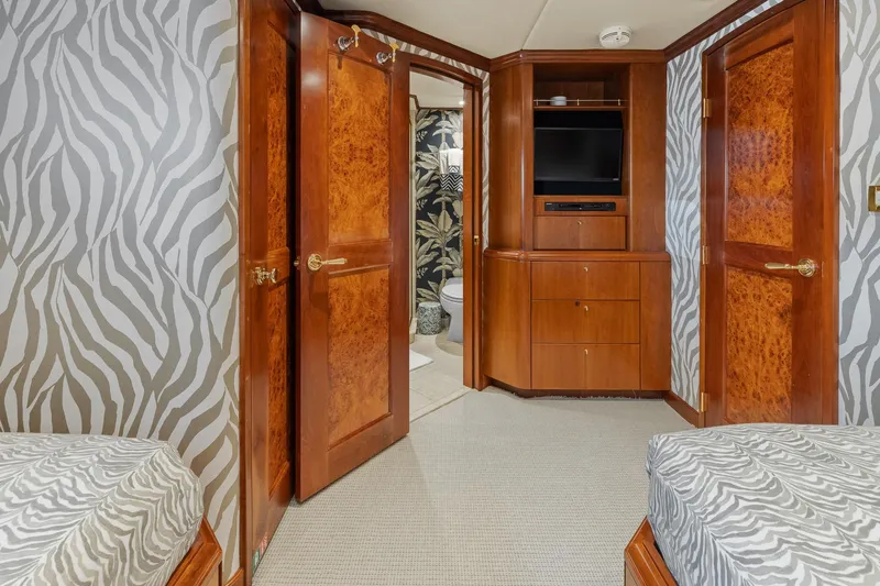  Yacht Photos Pics Luxurious 1999 Trinity Yachts Raised Pilothouse interior with zebra-patterned decor and wooden cabinetry.