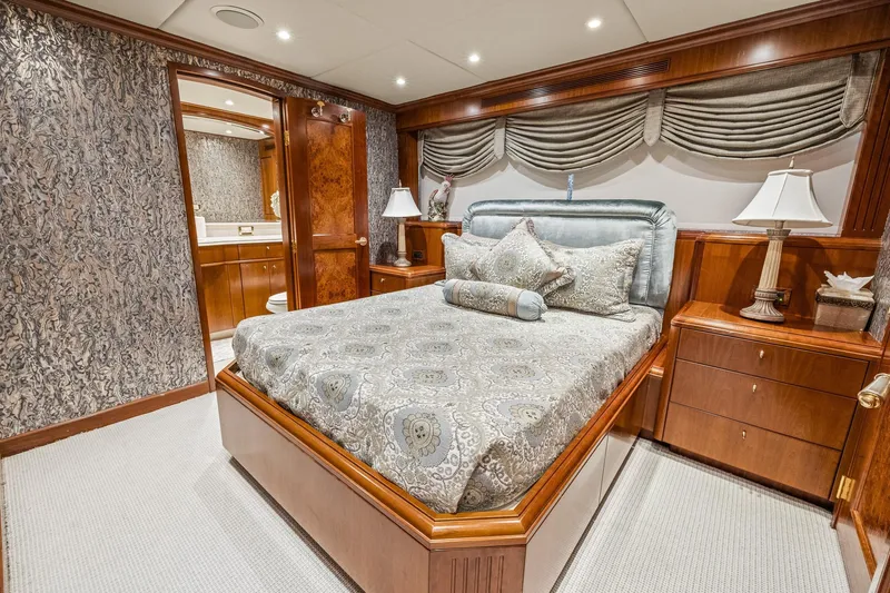  Yacht Photos Pics Luxurious bedroom on 1999 Trinity Yachts Raised Pilothouse with elegant decor and wood finishes.