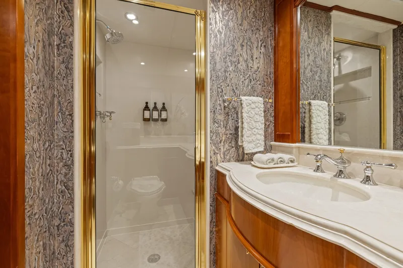  Yacht Photos Pics Luxurious bathroom on 1999 Trinity Yachts Raised Pilothouse, featuring elegant marble and wood finishes.