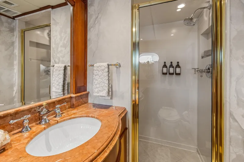  Yacht Photos Pics Luxurious yacht bathroom with marble sink and glass shower, Trinity Yachts Raised Pilothouse 1999.