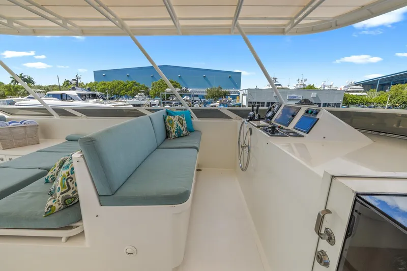  Yacht Photos Pics Luxurious 1999 Trinity Yachts Raised Pilothouse with spacious seating and modern navigation equipment.