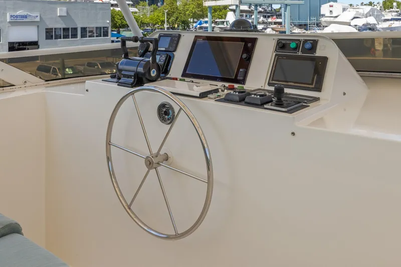 Yacht Photos Pics 1999 Trinity Yachts Raised Pilothouse helm with steering wheel and navigation controls.