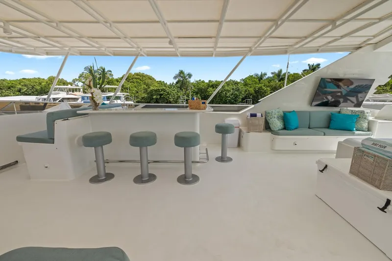  Yacht Photos Pics Luxurious 1999 Trinity Yachts Raised Pilothouse with elegant outdoor seating and bar area.