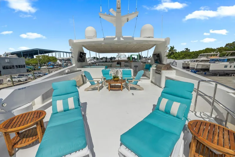  Yacht Photos Pics Luxurious 1999 Trinity Yachts Raised Pilothouse with spacious sun deck and turquoise loungers.