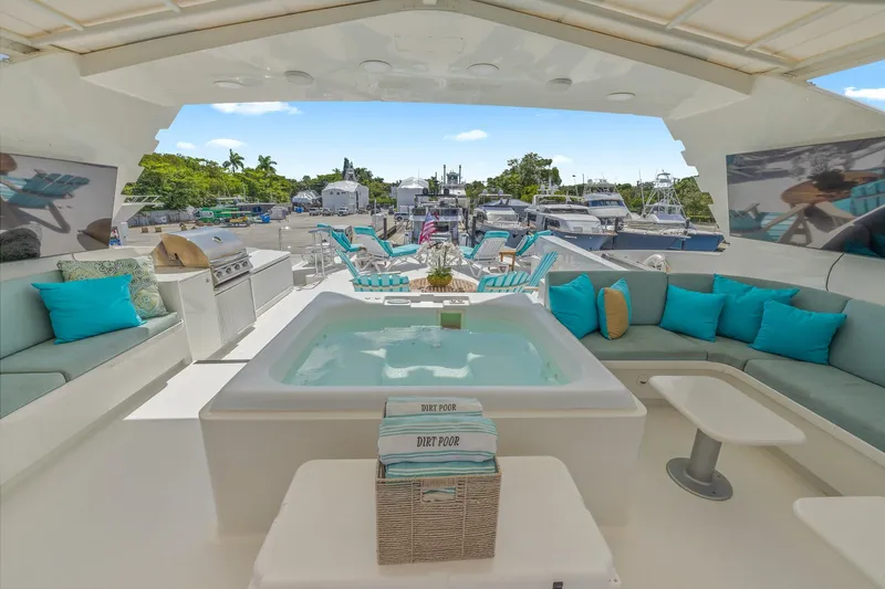  Yacht Photos Pics Luxurious 1999 Trinity Yachts Raised Pilothouse with jacuzzi, seating, and grill on deck.