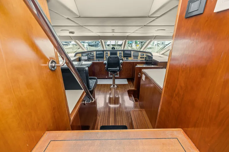  Yacht Photos Pics 1999 Trinity Yachts Raised Pilothouse interior with wooden finishes and navigation equipment.
