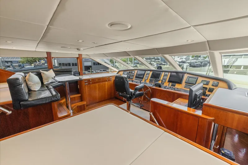  Yacht Photos Pics Luxurious 1999 Trinity Yachts Raised Pilothouse interior with modern navigation equipment.
