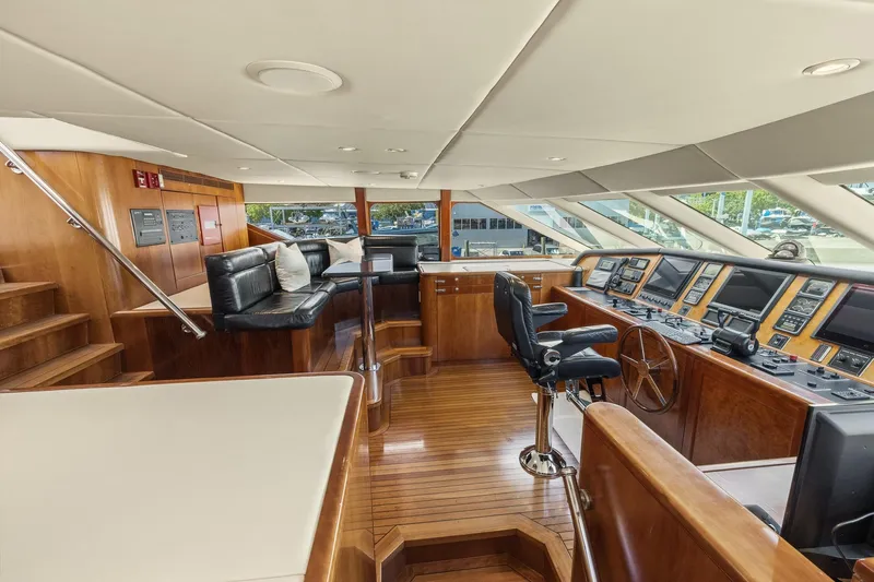  Yacht Photos Pics Luxurious 1999 Trinity Yachts Raised Pilothouse interior with wood finishes and modern navigation equipment.