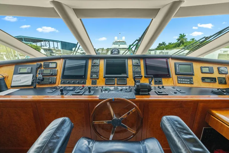  Yacht Photos Pics Luxurious 1999 Trinity Yachts Raised Pilothouse with advanced navigation controls and panoramic view.