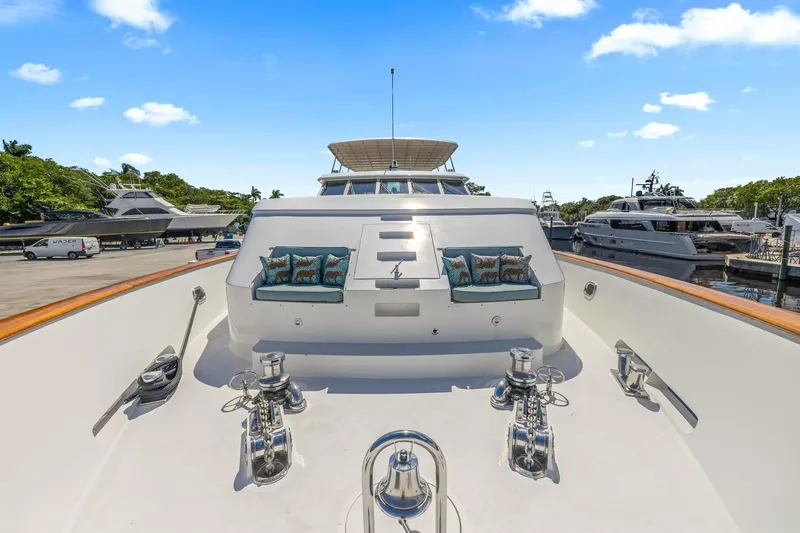  Yacht Photos Pics Luxury 1999 Trinity Yachts Raised Pilothouse at marina, featuring spacious deck and elegant design.