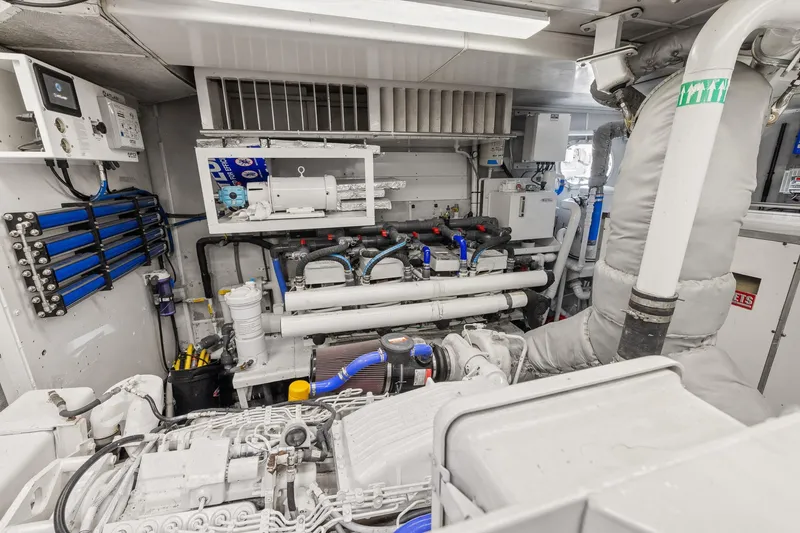  Yacht Photos Pics Engine room of 1999 Trinity Yachts Raised Pilothouse, showcasing mechanical systems and equipment.