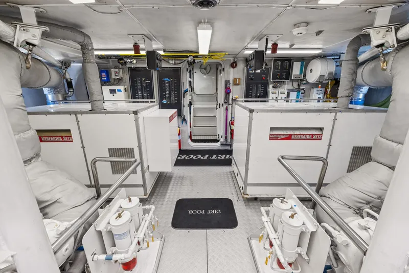  Yacht Photos Pics Engine room of 1999 Trinity Yachts Raised Pilothouse, featuring generator sets and control panels.