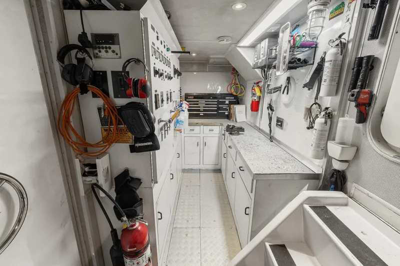  Yacht Photos Pics Engine room of 1999 Trinity Yachts Raised Pilothouse, featuring control panels and safety equipment.