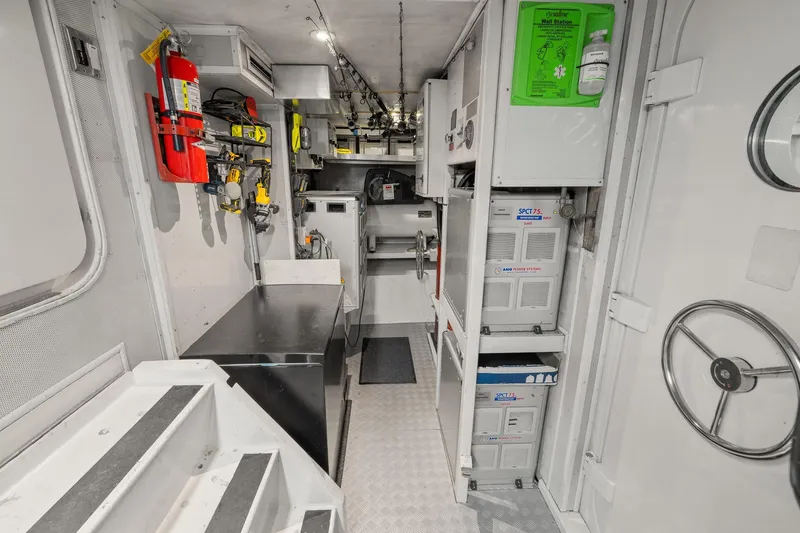  Yacht Photos Pics Engine room of 1999 Trinity Yachts Raised Pilothouse, featuring equipment and safety gear.