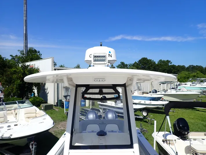  Yacht Photos Pics 2020 Regulator 23 boat with radar, parked outdoors under clear blue sky.