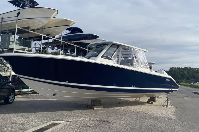  Yacht Photos Pics 2024 Pursuit S 328 Sport boat on display in a marina setting.