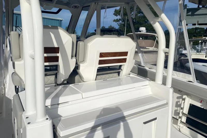  Yacht Photos Pics 2024 Pursuit S 328 Sport boat interior with white seating and sleek design.