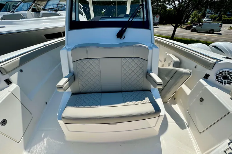  Yacht Photos Pics 2024 Pursuit S 328 Sport boat interior with cushioned seating and modern design.