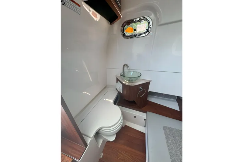  Yacht Photos Pics 2024 Pursuit S 328 Sport boat interior with modern bathroom amenities.