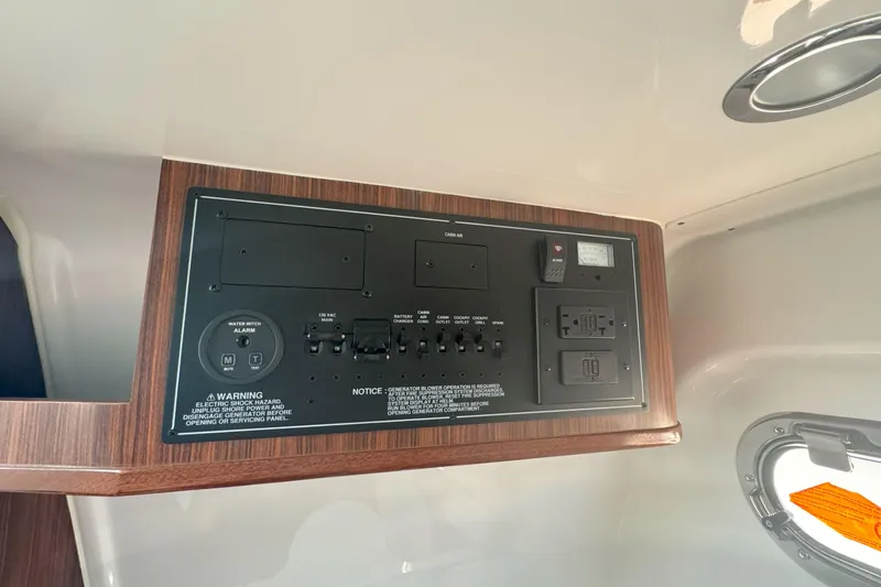  Yacht Photos Pics 2024 Pursuit S 328 Sport control panel with switches and outlets in cabin.