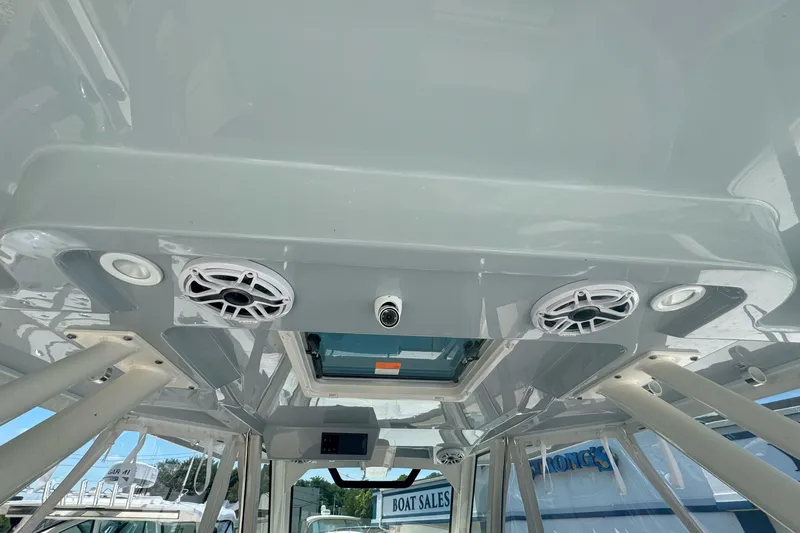  Yacht Photos Pics 2024 Pursuit S 328 Sport boat interior with speakers and lighting fixtures.