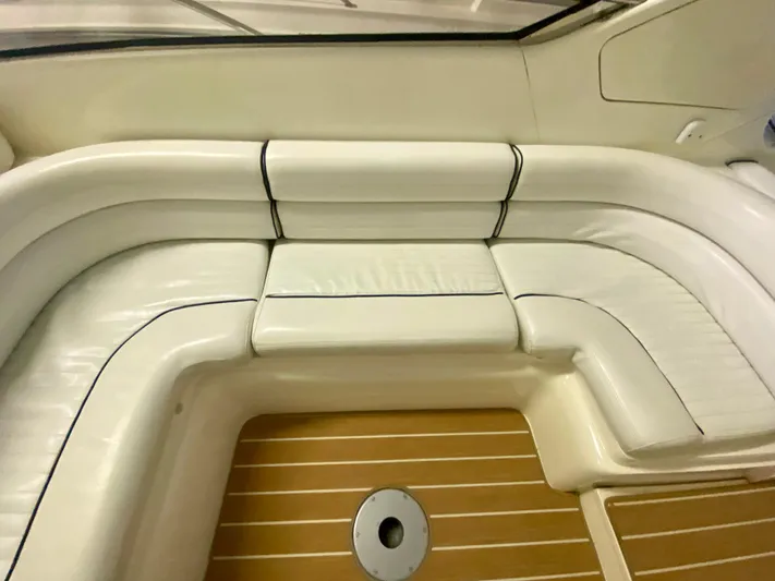 Tude Yacht Photos Pics 1995 Sunseeker Apache 45 boat interior with white leather seating and wooden flooring.