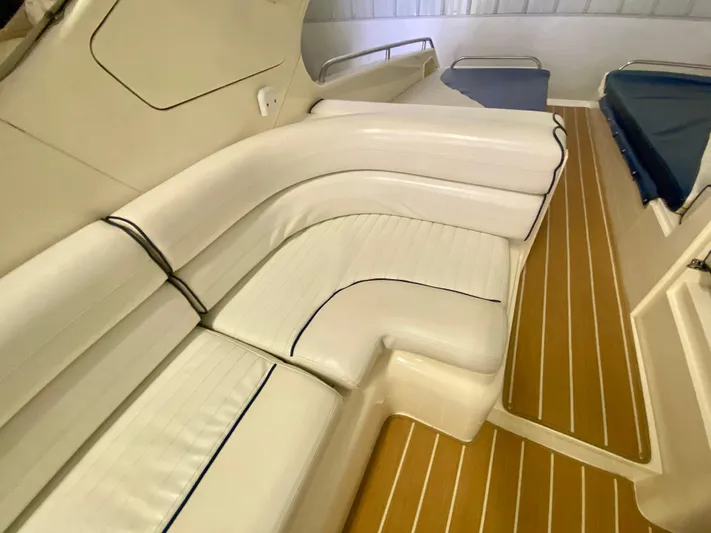 Tude Yacht Photos Pics Interior seating of 1995 Sunseeker Apache 45 with white leather upholstery and wooden flooring.