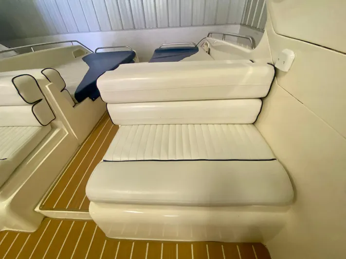 Tude Yacht Photos Pics Interior seating of a 1995 Sunseeker Apache 45 boat with white upholstery.