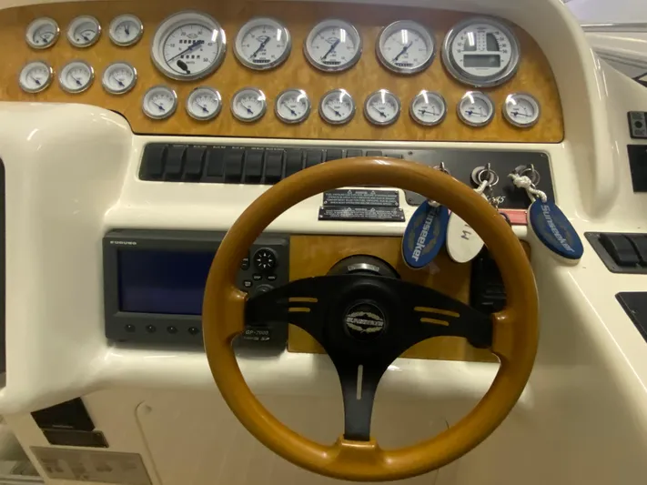 Tude Yacht Photos Pics 1995 Sunseeker Apache 45 dashboard with gauges, steering wheel, and keys.