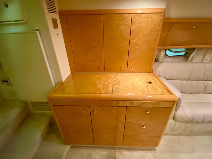 Tude Yacht Photos Pics Interior of 1995 Sunseeker Apache 45 yacht with wooden cabinetry and beige seating.