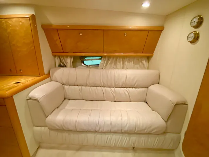 Tude Yacht Photos Pics Interior of 1995 Sunseeker Apache 45 yacht with beige leather sofa and wooden cabinets.