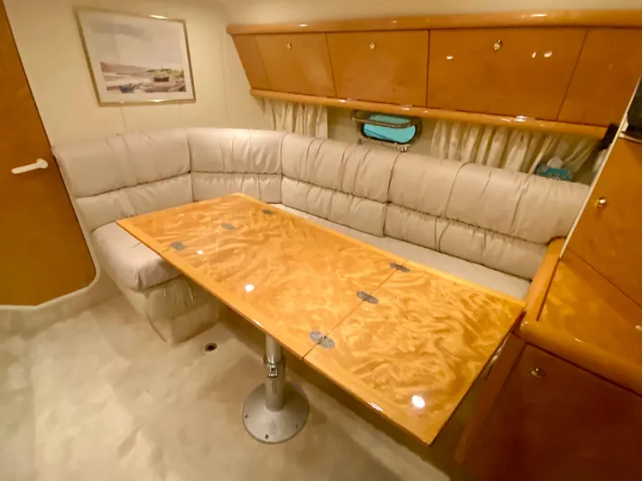 Tude Yacht Photos Pics Interior of 1995 Sunseeker Apache 45 yacht with beige leather seating and wooden table.