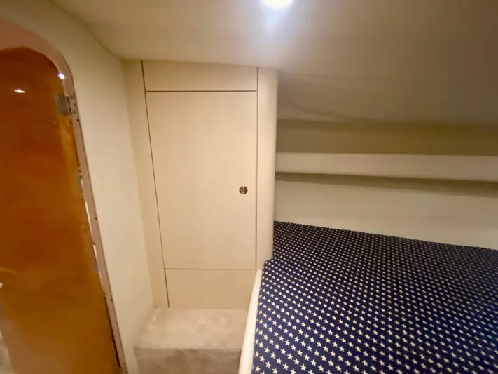 Tude Yacht Photos Pics Interior cabin of 1995 Sunseeker Apache 45 with star-patterned bedding.