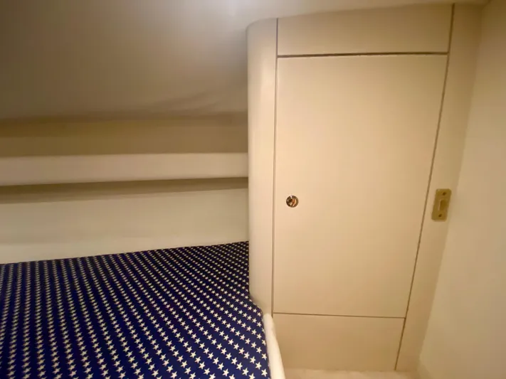 Tude Yacht Photos Pics Interior cabin of 1995 Sunseeker Apache 45 with star-patterned bedding.