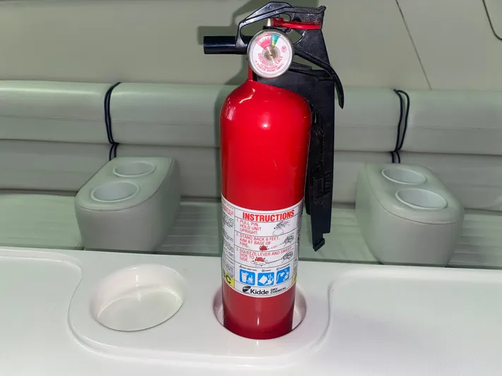 Tude Yacht Photos Pics Red fire extinguisher on a 1995 Sunseeker Apache 45 boat with white seating.
