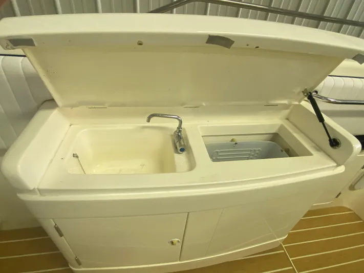 Tude Yacht Photos Pics Sunseeker Apache 45 1995 boat sink and storage compartment with open lid.