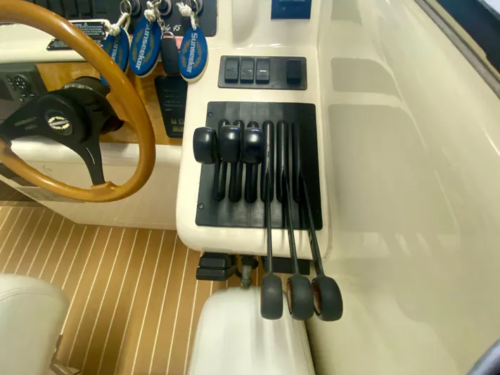 Tude Yacht Photos Pics Sunseeker Apache 45 1995 boat controls and steering wheel in cockpit.