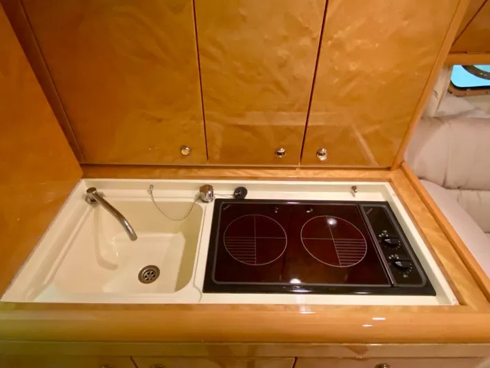 Tude Yacht Photos Pics 1995 Sunseeker Apache 45 yacht kitchen with sink and electric stove.