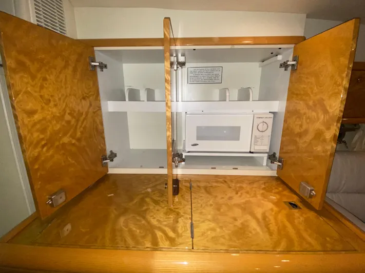 Tude Yacht Photos Pics Open cabinet with microwave in 1995 Sunseeker Apache 45 yacht.