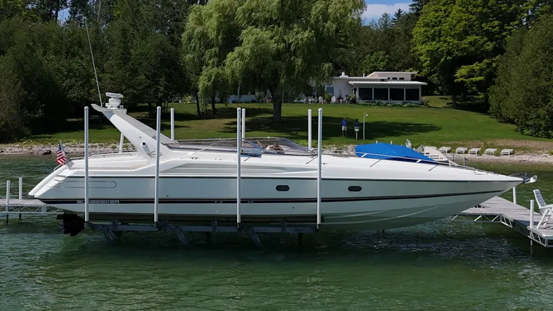 Tude Yacht Photos Pics 1995 Sunseeker Apache 45 yacht docked on a serene lake.