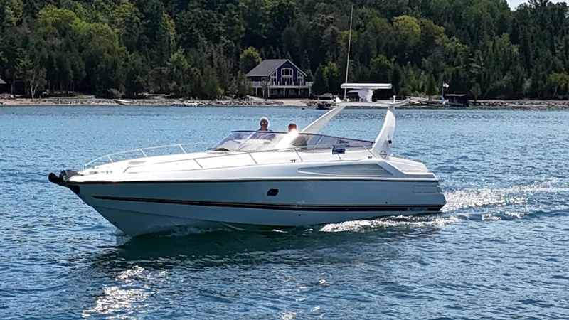 Tude Yacht Photos Pics 1995 Sunseeker Apache 45 cruising on a scenic lake with forested shoreline.