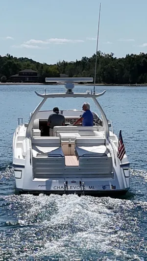 Tude Yacht Photos Pics 1995 Sunseeker Apache 45 yacht cruising on a sunny lake.