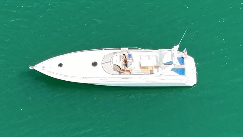 Tude Yacht Photos Pics Aerial view of 1995 Sunseeker Apache 45 yacht on turquoise water.