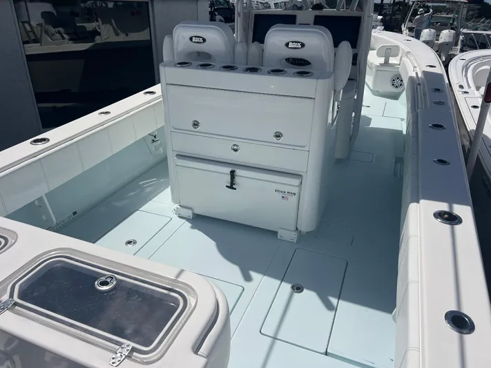  Yacht Photos Pics 2019 Contender 32 ST boat interior with seating and storage compartments.