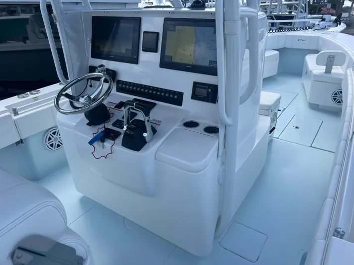  Yacht Photos Pics 2019 Contender 32 ST boat cockpit with dual screens and steering wheel.